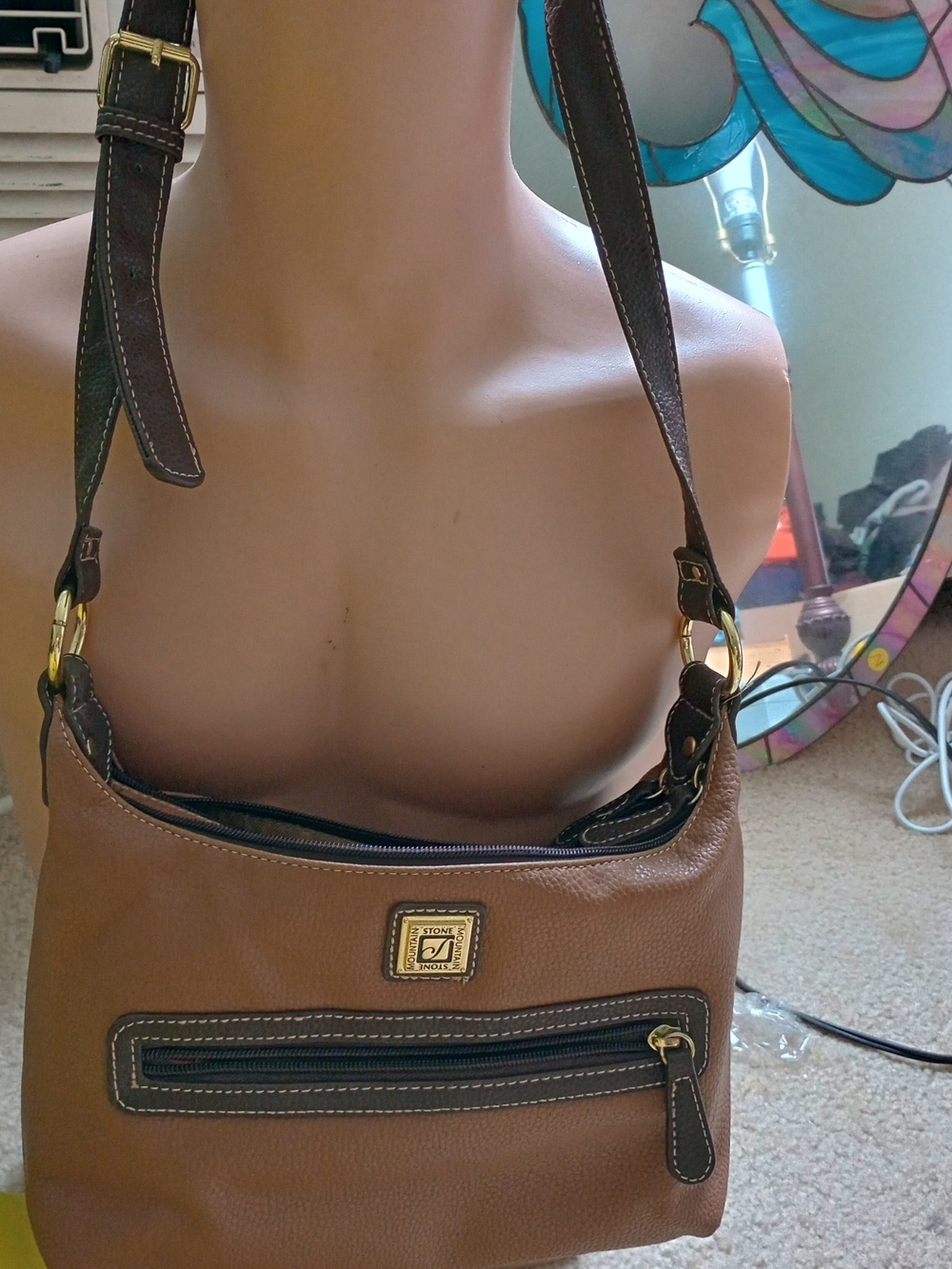 Stone Mountain pebbled leather shoulder bag in brown with a matching tan trim.